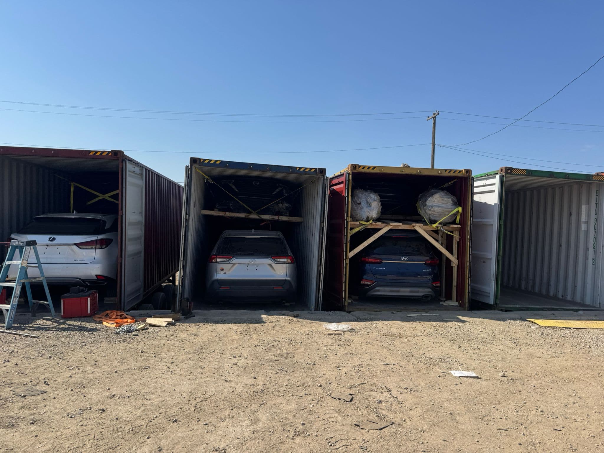 Multiple shipping containers loaded with vehicles ready for export from Canada to Europe