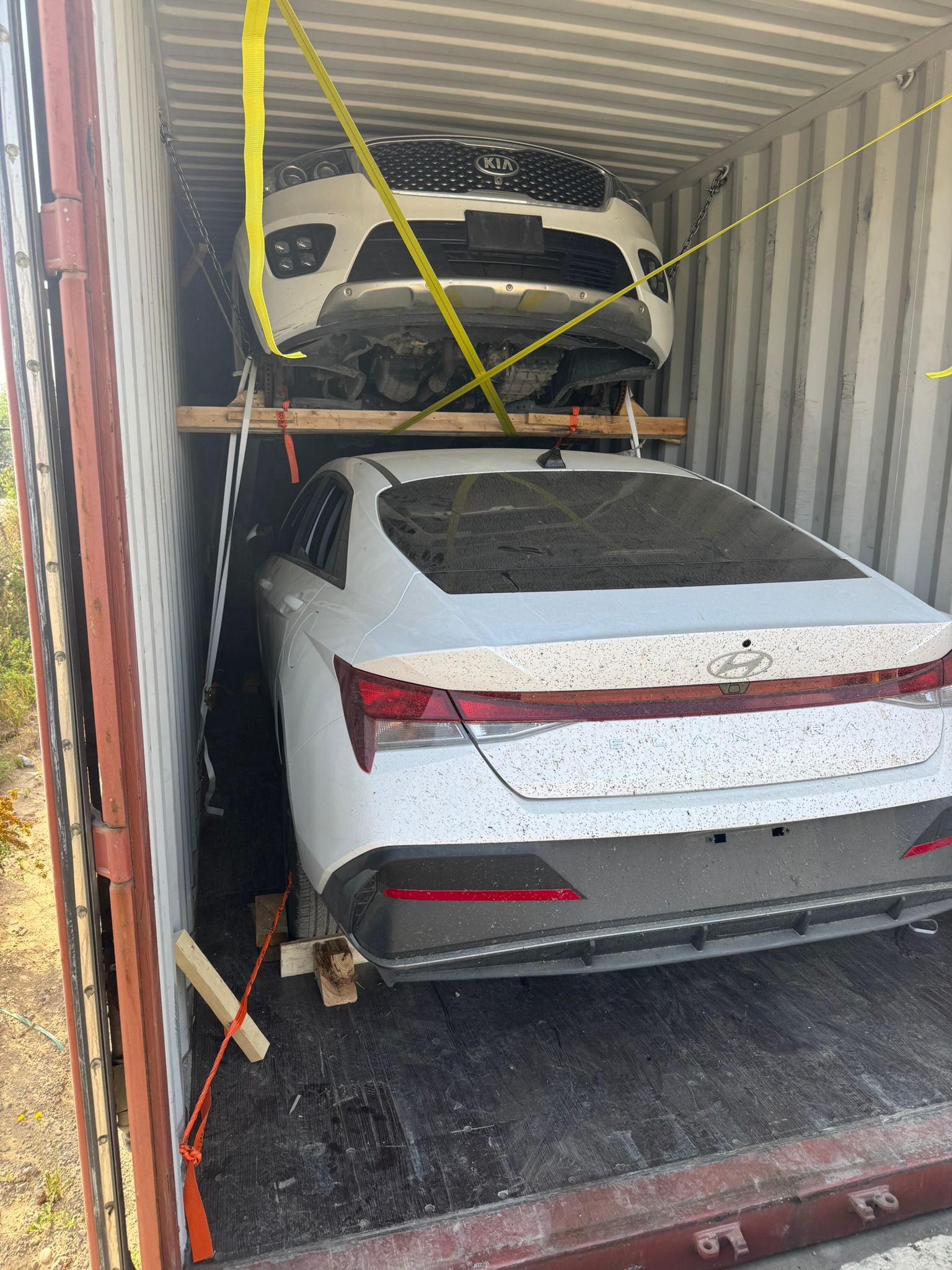 Vehicles securely packed and stacked inside shipping containers for overseas export